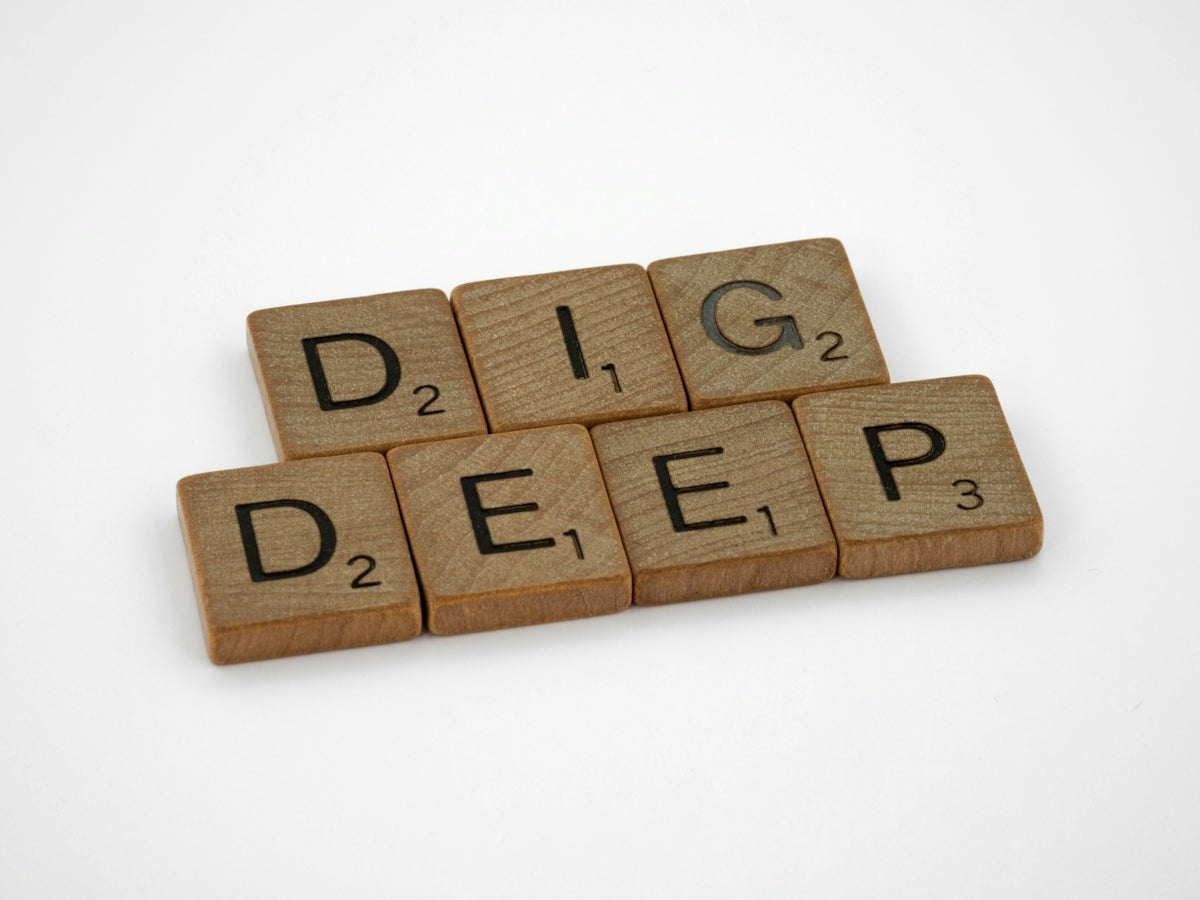 a set of scrabble tiles spelling the word dig deep