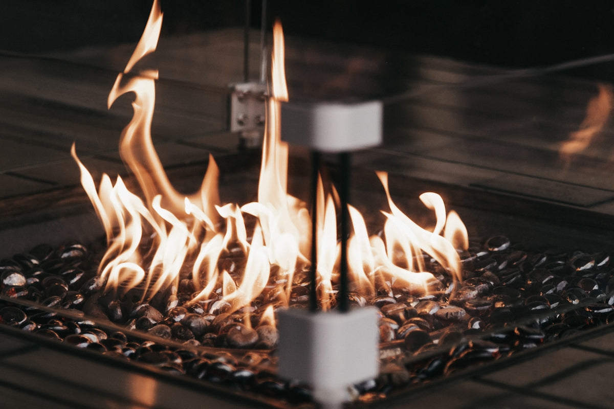 a close up of a fire pit with flames coming out of it
