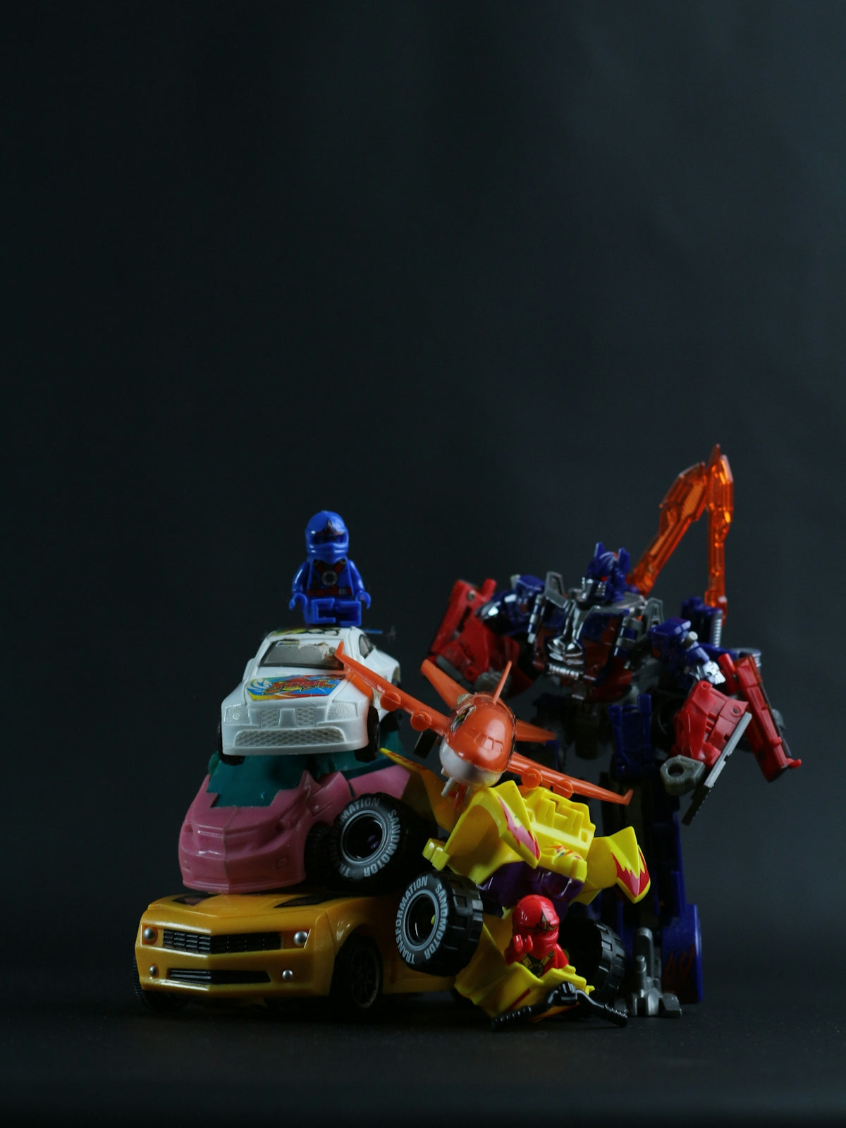 a group of toy cars sitting on top of each other