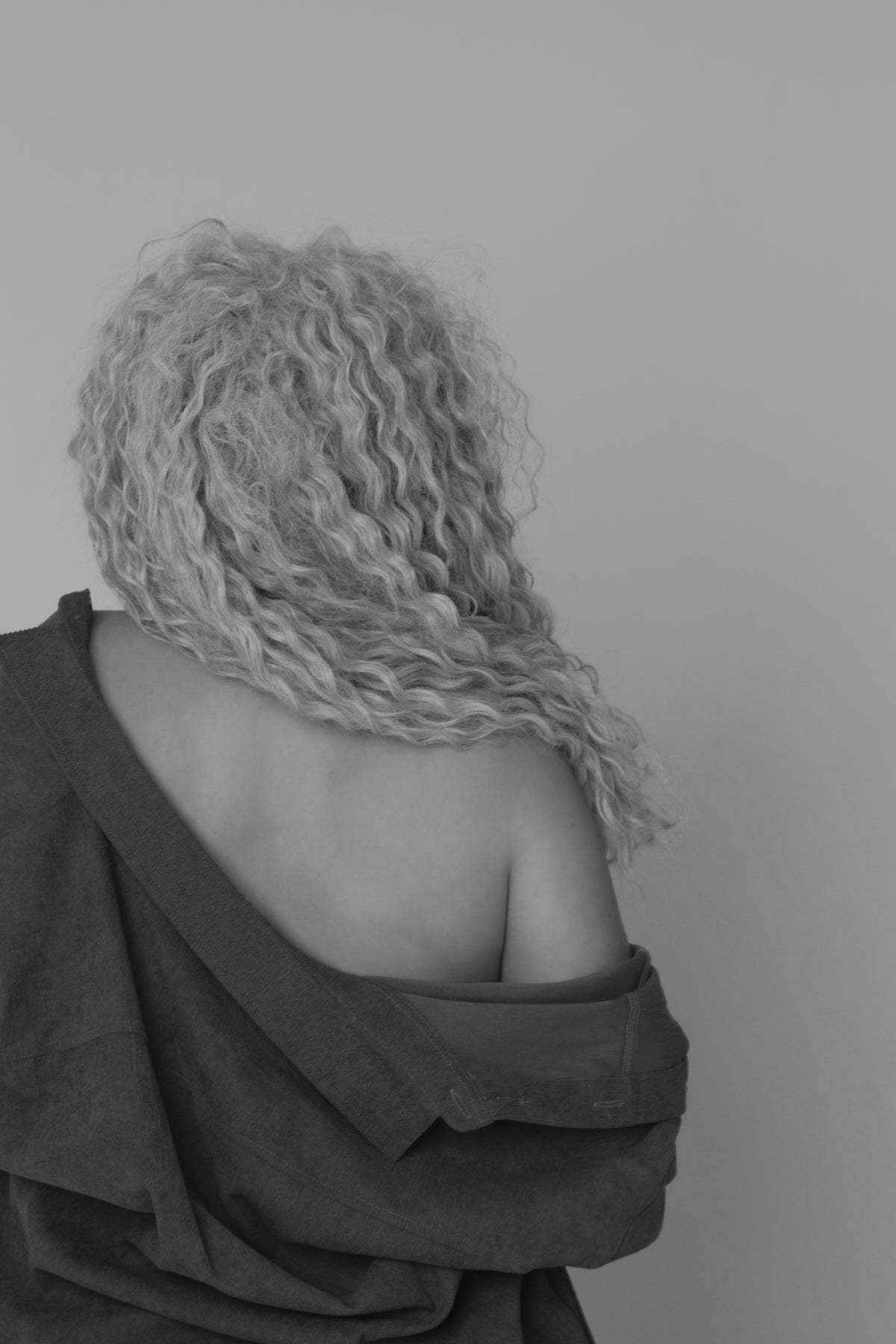 the back of a woman's head with curly hair