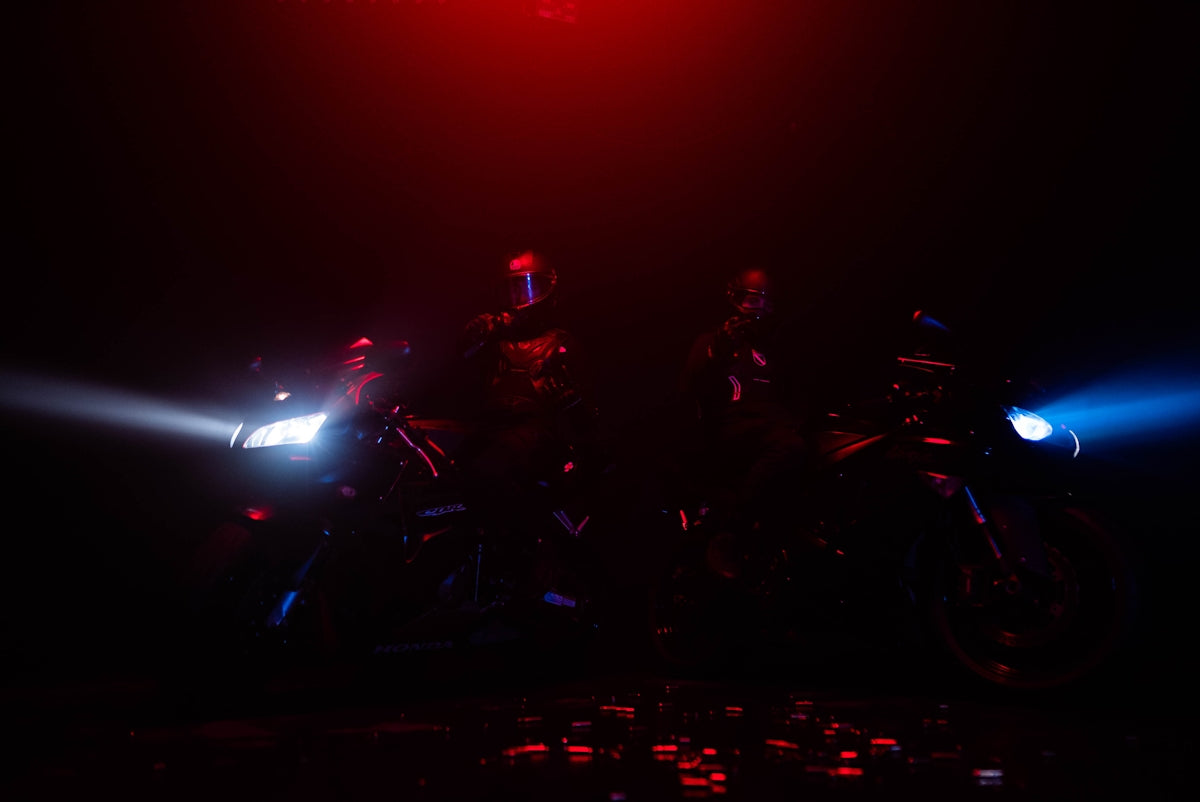 two motorcyclists on their bikes in the dark