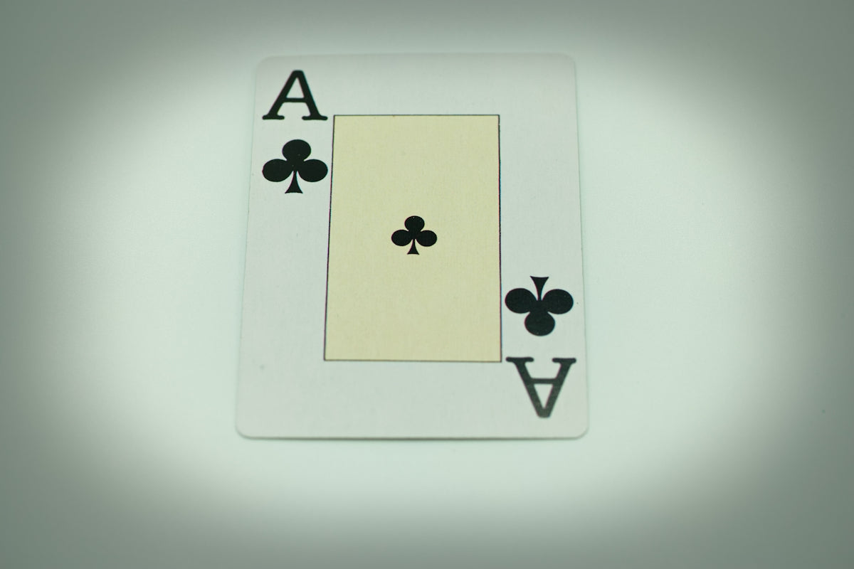 a white playing card with four of spades