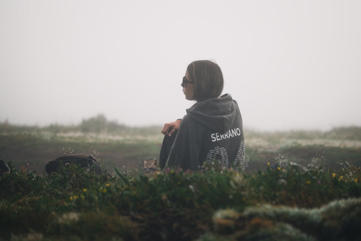 A man in a hoodie standing in a field