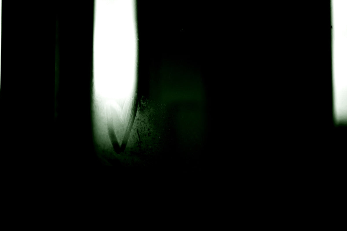 A blurry photo of a person holding a cell phone