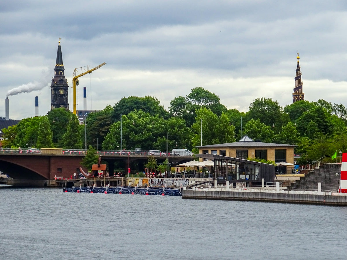 Cityscape with bridge, canal, and historic church spires