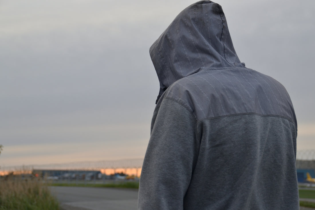 Person in a hoodie looking away from camera