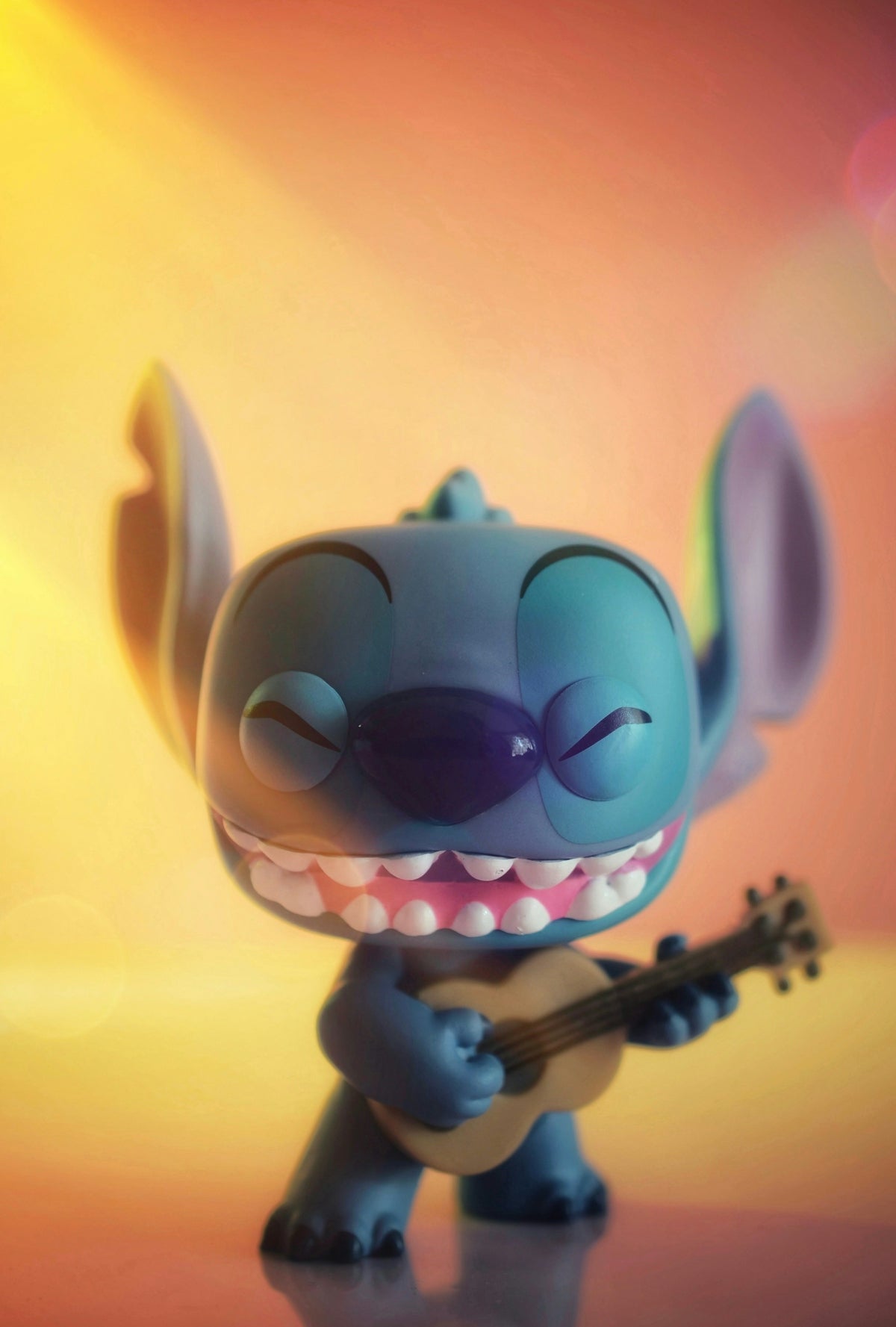A stitch toy playing a ukulele with a ukulele