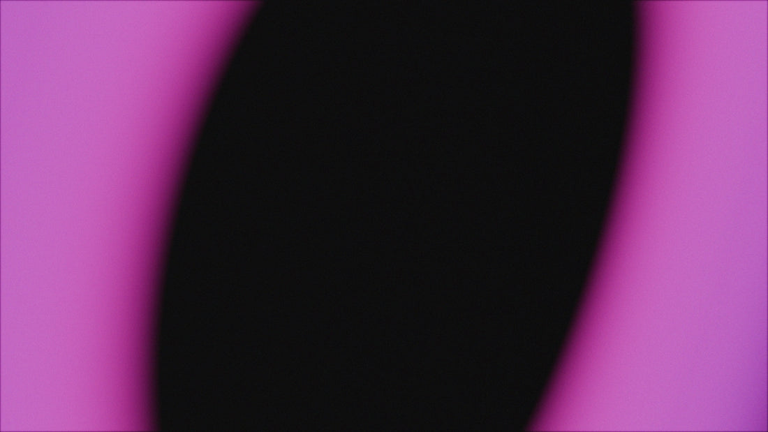 A black shape against a pink background